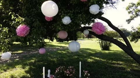 Festival decorative string lights hang and glow outdoors at night. Stock Footage 148645470