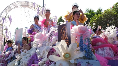 Festival float performers greet crowd at parade Stock Footage 344096390