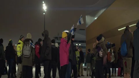 Festival goers with Finnish flags queue outside event at LUX Helsinki Stock Footage 201137940