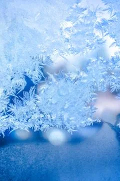 Festive background of blue ice on window, close up Stock Photos
