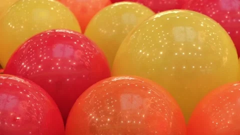 Festive background of bouncing red orange yellow balls. closeup. selective focus Stock Footage 239925367