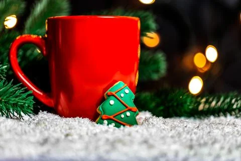 Festive background with a Cup of Tea and gingerbread tree on a snow backgroun Stock Photos