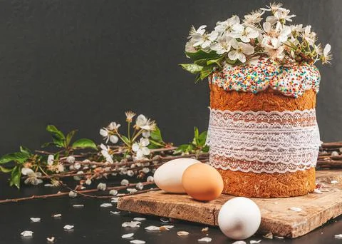 Festive background with Easter cake and spring flowering cherry branches Stock Photos