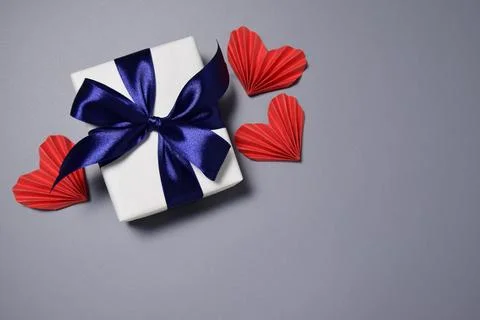 Festive background with a gift and hearts Stock Photos