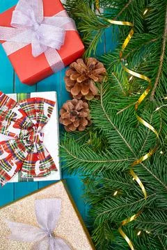 Festive background. Gift boxes with bows with fir branches and lights Stock Photos