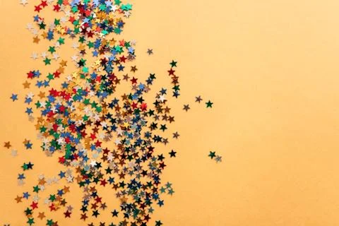Festive background of multi-colored confetti stars Stock Photos