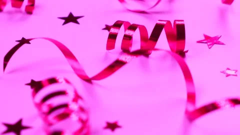 Festive background with pink serpentine and confetti stars Stock Footage 212921889