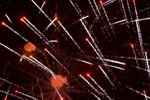 Festive background red rays of fireworks on a dark background. Stock Photos