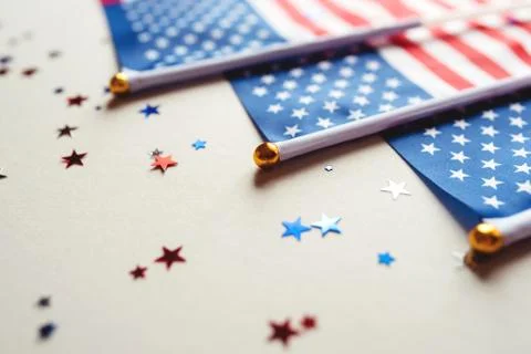 Festive background with US flags and confetti. Stock Photos