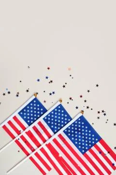 Festive background with US flags and confetti. Stock Photos
