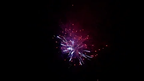 Festive background.Fireworks exploding brightly against the dark sky Stock Footage 145972064
