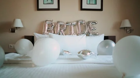Festive balloons on the bed for the bride. The bride's formal morning at the Stock Footage 252196703
