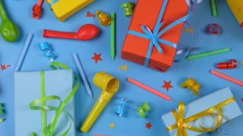 Festive blue background with gift boxes, candles, serpentine and balls top view Stock Footage 224525197