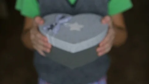 Festive box in the shape of heart in children's hands Stock Footage 82787092