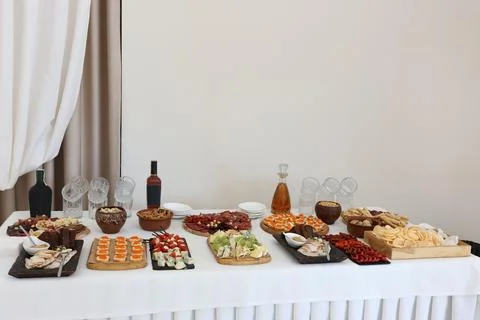 Festive buffet table with assorted appetizers, cheeses, cured meats and snack Stock Photos
