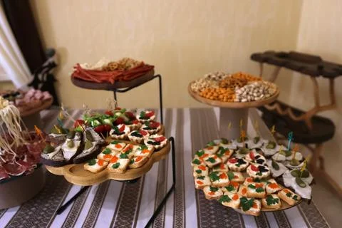 Festive buffet table with assorted canapes, tartlets, caviar, vegetables and  Stock Photos