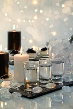 Festive buffet with vodka, black cavier and canddles. Celebration concept for 스톡 사진