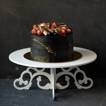 Festive cake on black background. Assorted pieces of chocolate and fresh berries Stock Photos