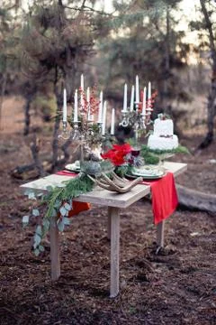 Festive cake on a table in a pine forest white candles red I years cooked Stock Photos