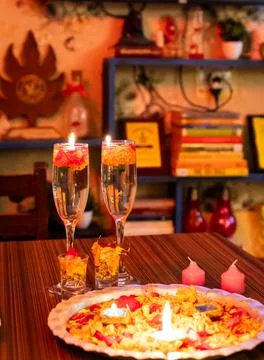 Festive Candlelight Table Decoration With Floating Flowers During Tradition.. Stock Photos