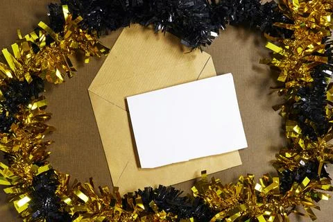 Festive Card With Envelope Surrounded By Gold And Black Tinsel For Holiday Celeb Stock Photos