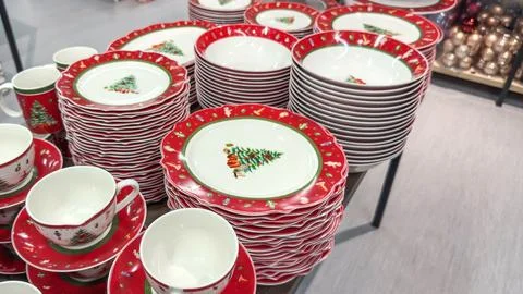Festive ceramic tableware with bright red borders and Christmas tree motifs n Stock Photos