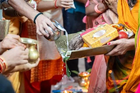 Festive chhath puja scene with devotee presenting chhath argha offerings Stock Photos