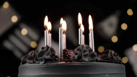 Festive chocolate cake with burning silver candles on black background close up Stock Footage 278600068