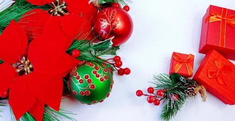 Festive Christmas background featuring red poinsettia flowers, decorative orn Stock Photos
