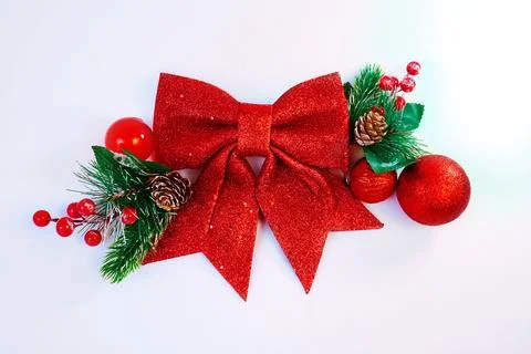 Festive Christmas background featuring a red glitter bow with pine branches Stock Photos