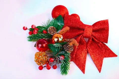 Festive Christmas background featuring a red glitter bow with pine branches Stock Photos