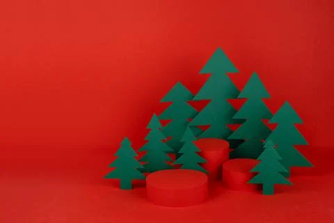 Festive Christmas background with three red cylinder podiums mockup with gree Stock Photos