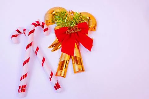 Festive Christmas composition featuring glossy gold candy cane ornaments Stock Photos