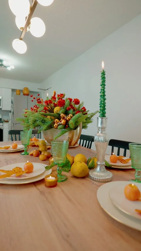 Festive Christmas dining table setting with natural citrus decor and candles Stock Footage 331136554