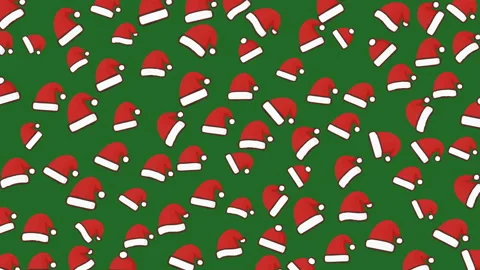 Festive Christmas Hats Pattern Bright Red Santa Caps on Green Background Stock Footage 319317397