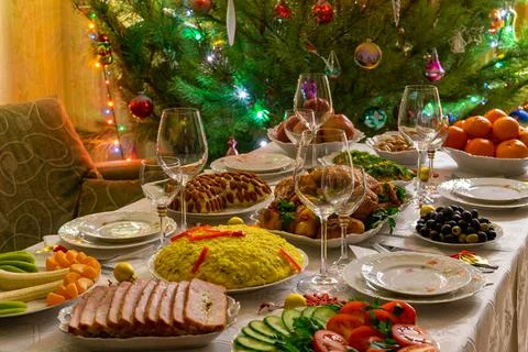 Festive Christmas served table against beautiful green pine tree decorated wi Stock Photos