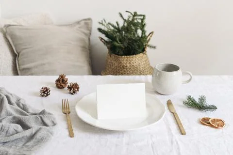 Festive Christmas table setting. Golden cutlery, spruce tree branch and dry 스톡 사진