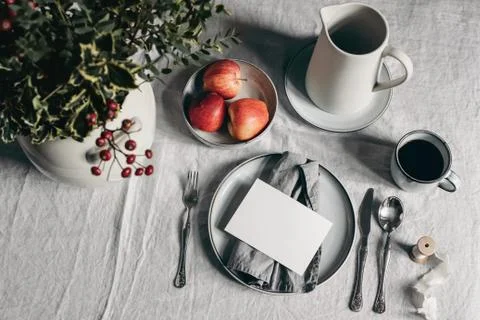 Festive Christmas table setting. Silver cutlery, bowl of apples on linen Fotos de archivo