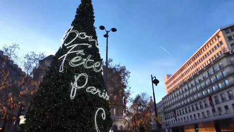 Festive Christmas tree with holiday lights outside Galeries Lafayette, Paris Stock Footage 303615254