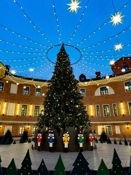 Festive Christmas tree with nutcracker decorations and glowing lights Stock Photos