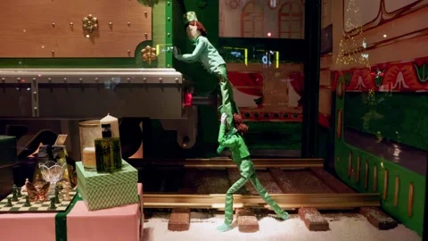 Festive Christmas window display in Paris boutique featuring performers in Stock Footage 295331838