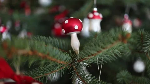A festive close-up of a Christmas tree adorned with whimsical red and white mush Stock Footage 294786943