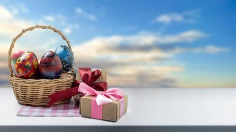 Festive composition featuring a wicker basket with hand-painted Easter eggs.. Stock Photos