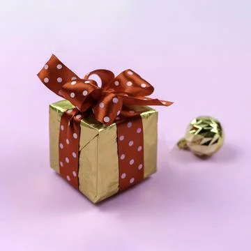 Festive composition. Gift box and golden balls Stock Photos