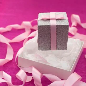 Festive composition with gift box on a bright pink background. Stock Photos