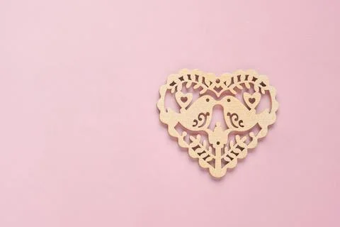 Festive composition with openwork white heart on pink background. Top view, c Stock Photos