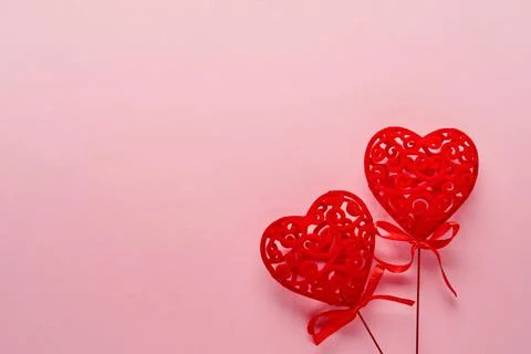 Festive composition with two red openwork white hearts on pink background. To Stock Photos