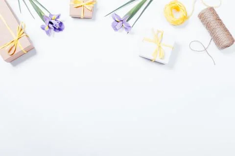 Festive composition on white table: flowers, boxes with gifts, ribbons Stock Photos