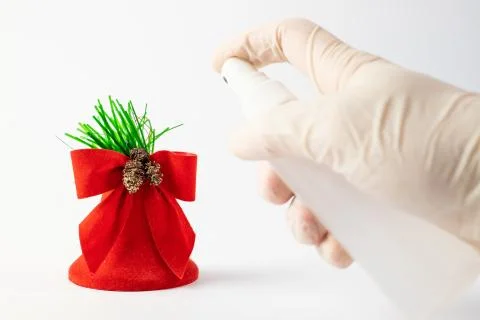 Festive concept of isolation. A gloved hand holding an antibacterial liquid.  Foto stock