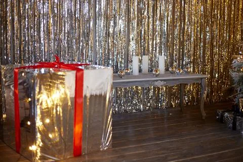 Festive dark background with silver light effects and a great gift Stock Photos